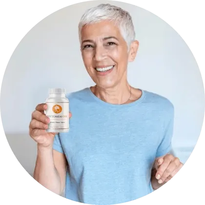 A woman with short gray hair in a light blue T-shirt holding a Phytomem One bottle